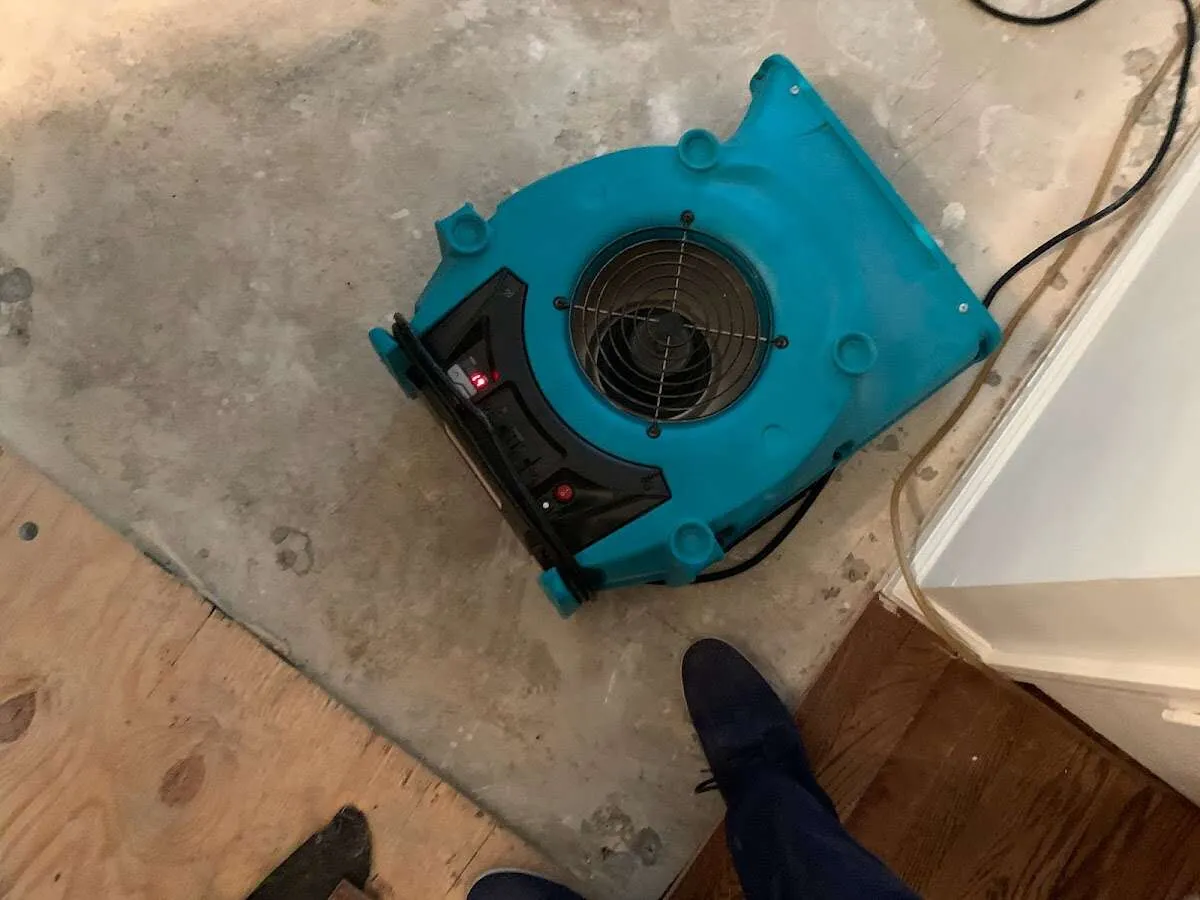 Air mover drying subfloor during Leak Detection & Repair in Crowley